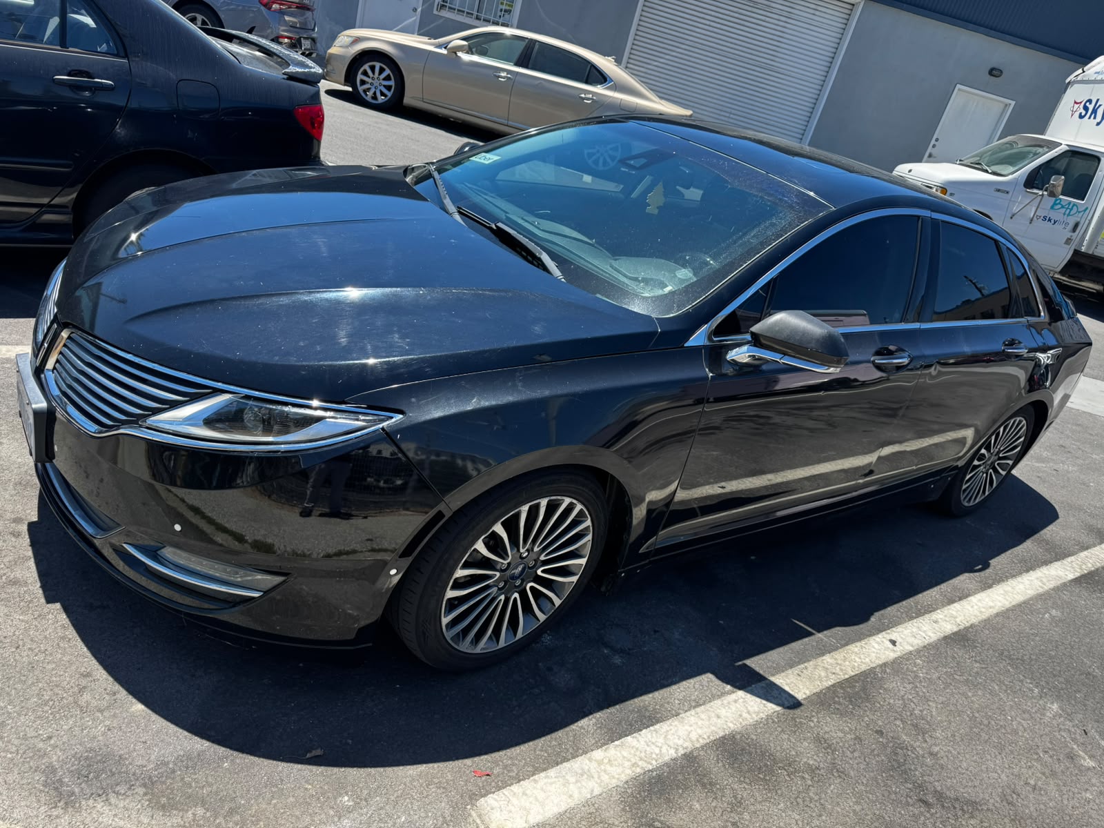 Black 2016 Lincoln MKZ Hybrid sedan on the PeakDeal Auto Sales lot